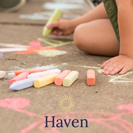 little girl drawing on a sidewalk with chalk