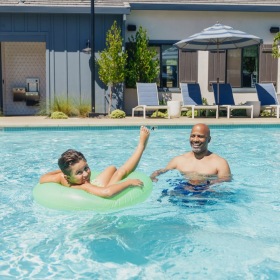 a father and son in a pool