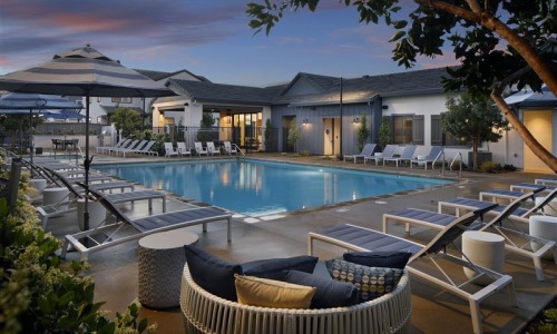 a pool with lounge chairs