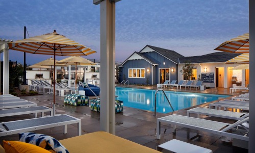 a pool with lounge chairs