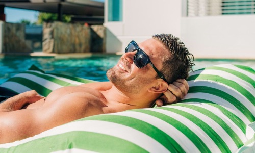 a man on a floaty in a pool