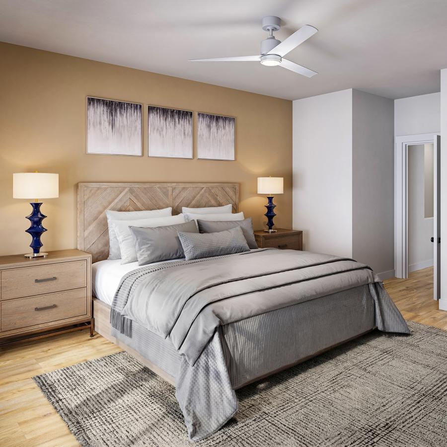 a bedroom with a bed and lamps